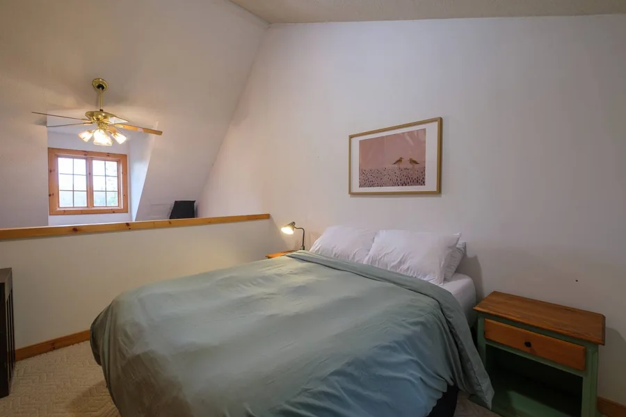 Loft-style queen bedroom overlooking the living area
