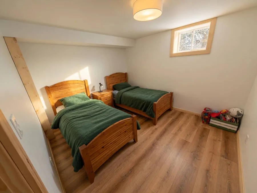Lower-level bedroom with two separate twin beds